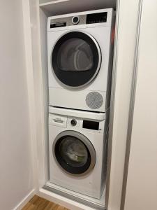 two washing machines and a washer and dryer in a room at Visconde II F in Ribeira Brava