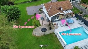 an aerial view of a house with a swimming pool at Gîte la p'tite rivière in Saint-Nabord