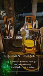 a wooden table with yellow chairs and a table with a table at Cozy Beach Studio with Kitchen by Casa in Kribi