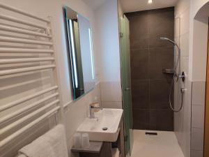 a bathroom with a sink and a shower at Pension Waldhof in Koppl +61 photos