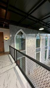 a balcony with a black railing and two windows at Villa Moon Terrace in Bang Khen