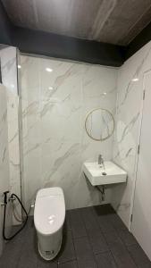 a bathroom with a toilet and a sink at Villa Moon Terrace in Bang Khen