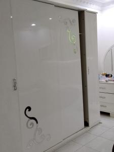 a white door with a green design on it at وادي جليل in As Sifyānī