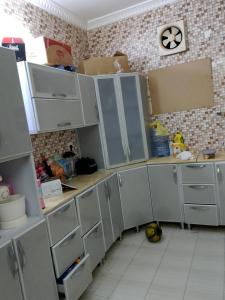 a kitchen with a bunch of cabinets and boxes at وادي جليل in As Sifyānī