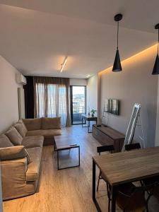 a living room with a couch and a table at Ameri Plaza Lilu Home apartment in Tbilisi City