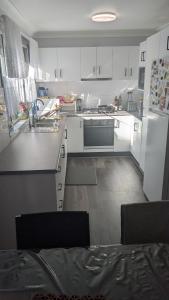 a kitchen with white cabinets and a stove top oven at Bidwill Garden in Bidwill