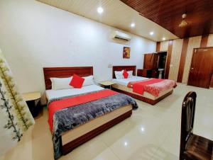 Giường trong phòng chung tại hotel grand