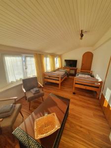 a living room with two beds and a table at Böhmerwald fun in Schwarzenberg am Bohmerwald