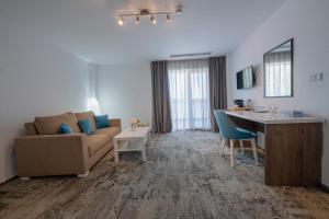 een woonkamer met een bank en een tafel bij Royal Hotel & Events in Băileşti