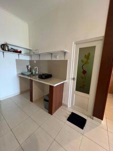 a kitchen with a desk and a counter in it at Azona Greens Uluwatu in Uluwatu