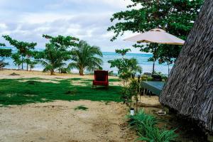 a table and an umbrella on the beach at Filmegs Seaside in Alegria
