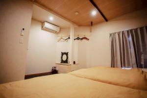 Postel nebo postele na pokoji v ubytování 本陣 Urawa Sauna