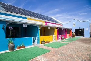 ストームス・リバーにあるStorms River Self Catering Apartmentsの太陽光パネルが設置されたカラフルな建物の列