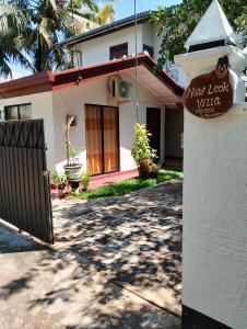 a house with a sign that reads new look villa at New Look villa in Mirissa