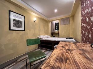 a room with a bed and a table and a chair at Front Stupa View in Kathmandu