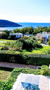 two chairs sitting on a patio with a view of the ocean at Villa Infinity View Athens Riviera in Anavissos