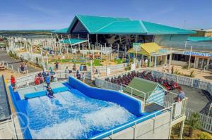 a water park with a water slide and people at Cosy Retreat in Selsey