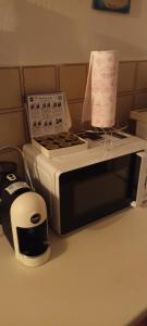 a microwave sitting on a counter next to a toaster at Aura House in Caiolo