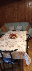 a table with a plate of fruit on it at Aura House in Caiolo