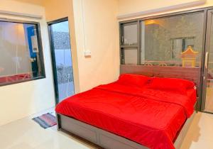 a red bed in a room with a large window at HR Hotel Batu in Batu +35 photos