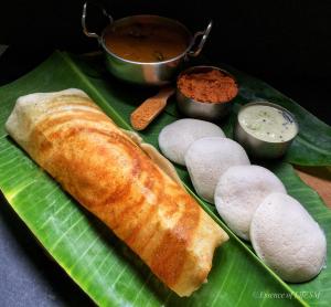 a plate of food with bread on a banana leaf at Mystique Copper Villa Homestay Karwar in Sadāshivgarh
