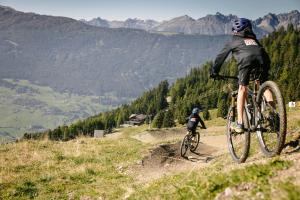 a person riding a bike on a mountain trail at Panorama Wildgrat in Wenns