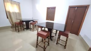 a dining room with two tables and some chairs at Mayabini The Village Homestay in Bindukuri