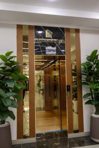 a lobby with a revolving door in a building at Floranta Hotel in Qarshi