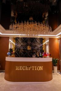 a chandelier hanging over a counter in a store at Floranta Hotel in Qarshi