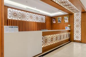 a hotel lobby with a reception counter and decorative glass at Ancyra Hotel - By Continent - فندق انكيرا in Medina