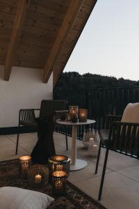 a patio with a table and chairs and candles at Das Dietrich - Landhaus 62 in Leibnitz