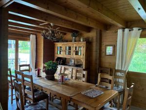 a dining room with a wooden table and chairs at Chalet Papillon in La Chapelle-dʼAbondance
