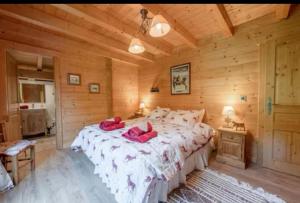a bedroom with a large bed in a wooden room at Chalet Papillon in La Chapelle-dʼAbondance