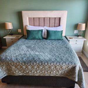 a bedroom with a large bed with two night stands at Bella Vista in Mossel Bay