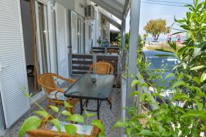 a table and chairs on the porch of a house at ILIOVASILEMA - Ηλιοβασίλεμα in Pefki