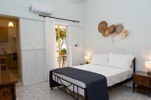 a bedroom with a bed with a hat on the wall at ILIOVASILEMA - Ηλιοβασίλεμα in Pefki