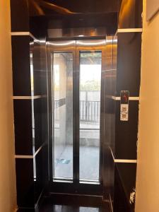 a glass door in a room with a window at Hotel kapil royal inn in Haridwār