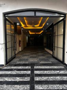an empty hallway of a building with glass doors at Hotel kapil royal inn in Haridwār