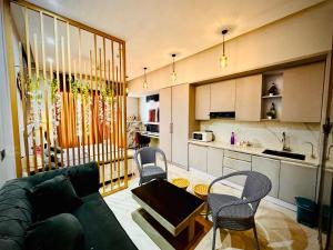 Nabhay Hotels and Resorts في غازي آباد: غرفة معيشة مع أريكة وكراسي ومطبخ +18 صورة