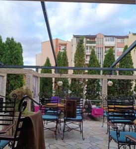 a patio with chairs and a table on a balcony at Modern Spacious ViS Raska Apartment! 5min Cafes in Raška