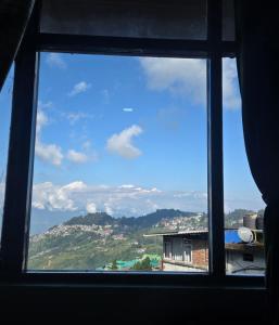 a view from a window of a city at Sonali Megh in Darjeeling