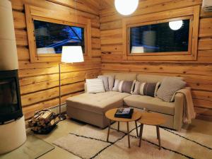 a living room with a couch and a table at Syöte Cottage in Syöte