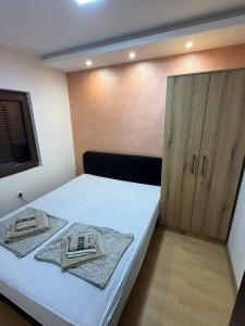 a bedroom with a bed with two towels on it at Apartman Stefan Zlatibor in Zlatibor