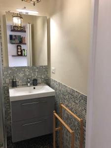 a bathroom with a sink and a mirror at Dormire nel cuore di Genova in Genoa