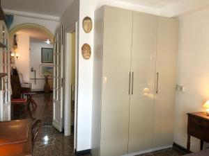 a white cabinet in a room with a hallway at Dormire nel cuore di Genova in Genoa