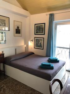 a bedroom with a bed with blue towels on it at Dormire nel cuore di Genova in Genoa