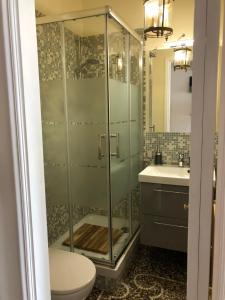 a bathroom with a shower with a toilet and a sink at Dormire nel cuore di Genova in Genoa