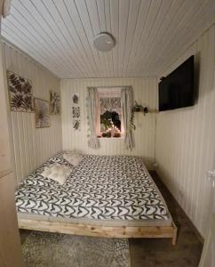 a bedroom with a large bed in a room at Ezera Roze Māja in Stacija Aglona +44 photos