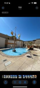 a view of a swimming pool with a tv screen at Suite no Boulevard suite hotel in Caldas Novas