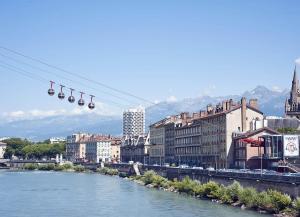 a group of bells hanging from a wire over a river at Studio place Victor Hugo in La Celle-sous-Gouzon +2 photos